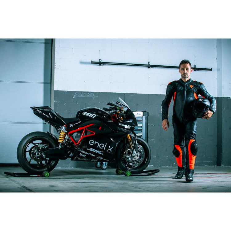 man staning next to a black energica ego racing electric bike